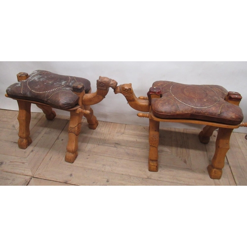 1141 - Pair of Middle Eastern Camel saddles with tooled leather seats