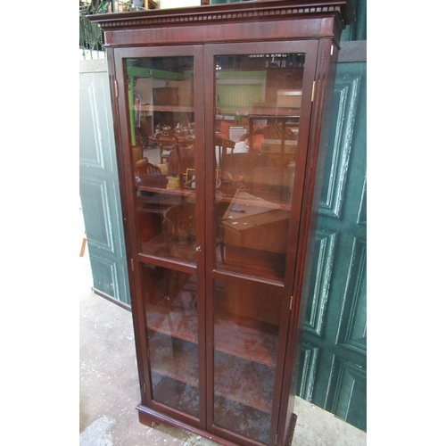 773 - Modern mahogany finish bookcase, with two glazed doors and five adjustable shelves on bracket feet, ... 