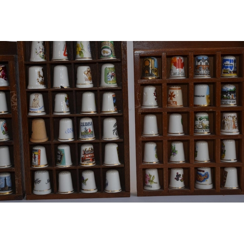 830 - A collection of (mostly) ceramic thimbles with wall hanging display cases, and a glass dome display ... 