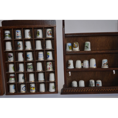 830 - A collection of (mostly) ceramic thimbles with wall hanging display cases, and a glass dome display ... 