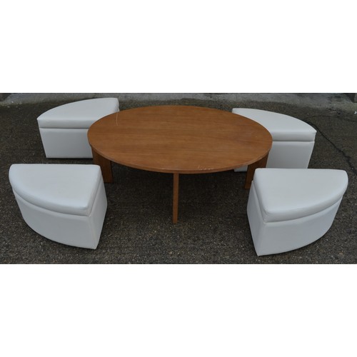 834 - An oval coffee table with 4 pull out padded seats, each with storage space inside. Table dimensions:... 