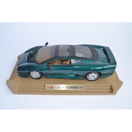 1148 - A Maisto 1/12 scale Jaguar XC220 (1992) attached to original base, no box. This is a large model, ov... 