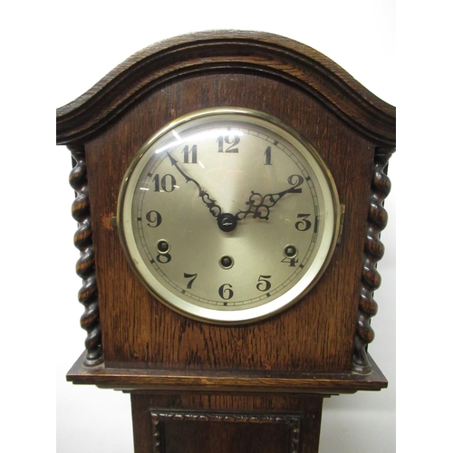 1219 - Small 1930's oak long case clock, arch molded top over barley twist columns on block feet, brass bez... 