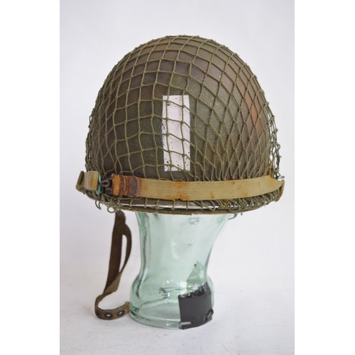 1190 - A US Army WWII M1 Mk1 front seam steel helmet, with liner, chin straps etc.