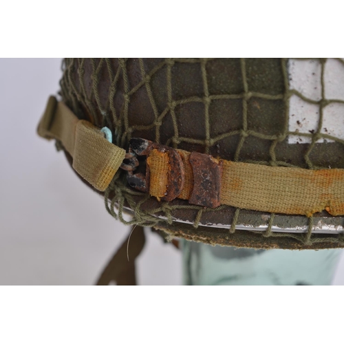 1190 - A US Army WWII M1 Mk1 front seam steel helmet, with liner, chin straps etc.