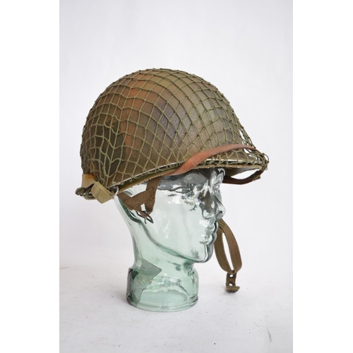 1190 - A US Army WWII M1 Mk1 front seam steel helmet, with liner, chin straps etc.