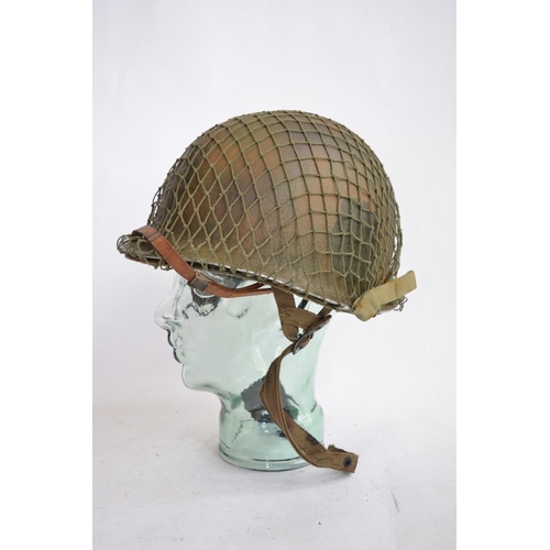 1190 - A US Army WWII M1 Mk1 front seam steel helmet, with liner, chin straps etc.