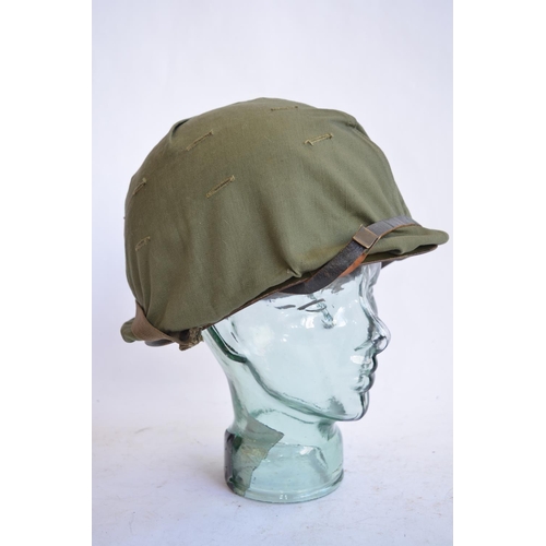 1191 - A US Army M1 Mk2 rear seam steel helmet, with liner, chin straps etc. Helmet has had markings applie... 