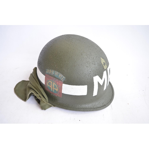 1191 - A US Army M1 Mk2 rear seam steel helmet, with liner, chin straps etc. Helmet has had markings applie... 