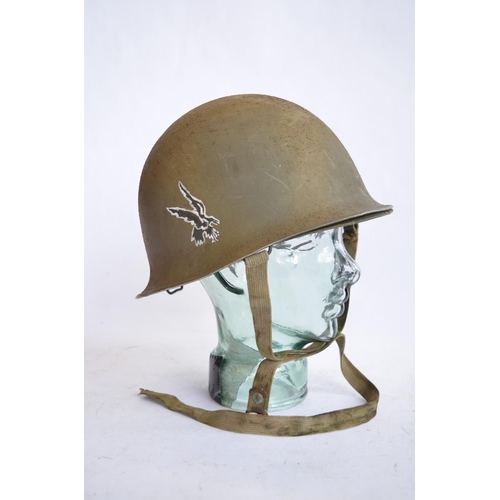 1192 - A French Army 1951 (MS1) post WWII rear seam steel helmet, with liner, straps etc. Unit logo on side... 