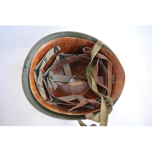 1192 - A French Army 1951 (MS1) post WWII rear seam steel helmet, with liner, straps etc. Unit logo on side... 