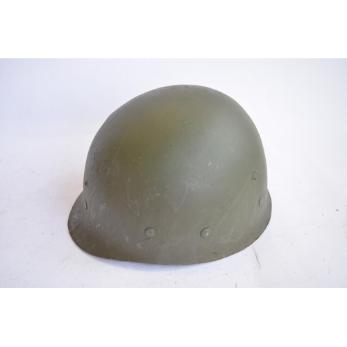 1192 - A French Army 1951 (MS1) post WWII rear seam steel helmet, with liner, straps etc. Unit logo on side... 