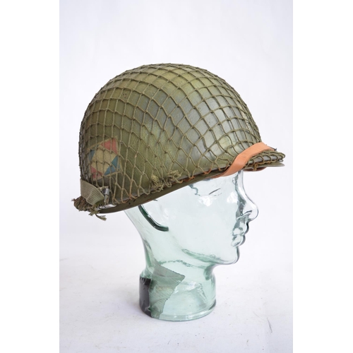 1193 - A US Army M1 Mk2 rear seam steel helmet, with liner, chin straps etc. Repainted/sprayed over with ad... 