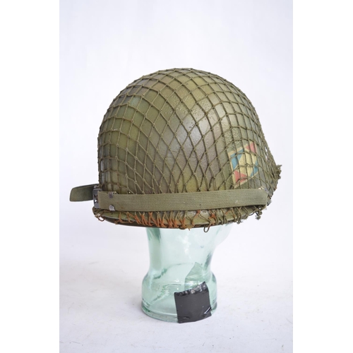 1193 - A US Army M1 Mk2 rear seam steel helmet, with liner, chin straps etc. Repainted/sprayed over with ad... 