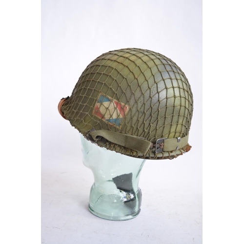 1193 - A US Army M1 Mk2 rear seam steel helmet, with liner, chin straps etc. Repainted/sprayed over with ad... 