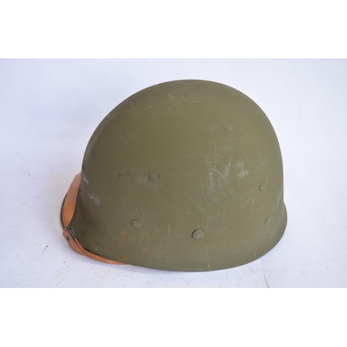 1193 - A US Army M1 Mk2 rear seam steel helmet, with liner, chin straps etc. Repainted/sprayed over with ad... 