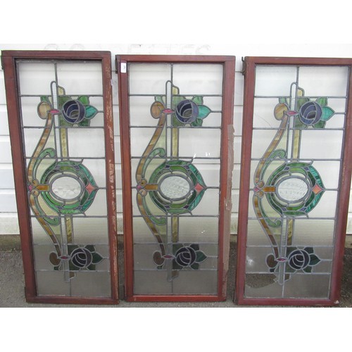 1205 - Three leaded stained glass window panels, decorated with scrolling foliage, W50cm H115cm (3)