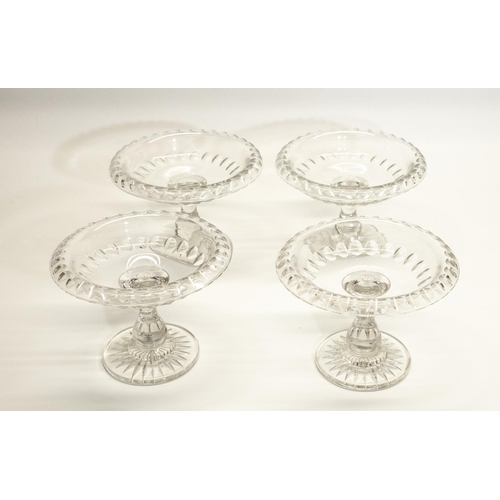 1135 - Set of four Georgian style glass Tazza, folded rim decorated with ovals, baluster stems with star cu... 