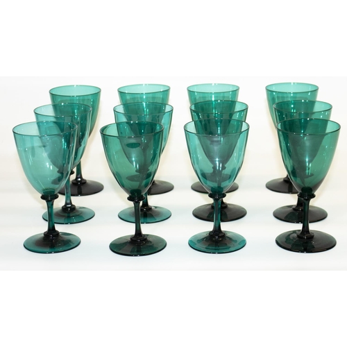 1136 - Set of twelve green glass wine glasses, bell shaped bowls on slender faceted stems and circular foot... 