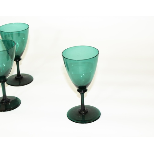 1136 - Set of twelve green glass wine glasses, bell shaped bowls on slender faceted stems and circular foot... 