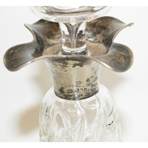 1130 - Edw.V11 hallmarked silver mounted decanter and stopper, wrythen tapering body decorated with trailin... 