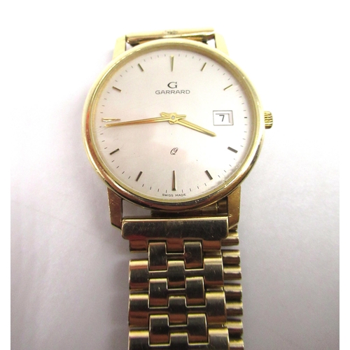 1078 - 1990's Garrard 9ct gold quartz wristwatch with date, signed cream dial with applied baton hours and ... 