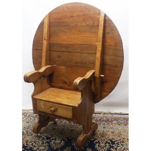 1396 - Early C20th waxed pine chair table, circular planked tilt top with shaped arms, solid seat and drawe... 