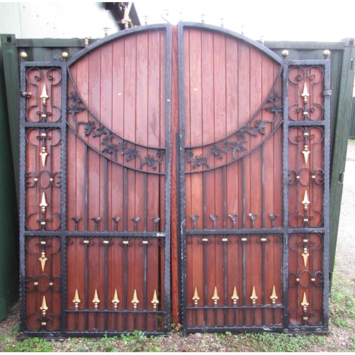 2304 - Pair of large cast iron and wooden courtyard gates with wood back with floral and spearhead design, ... 