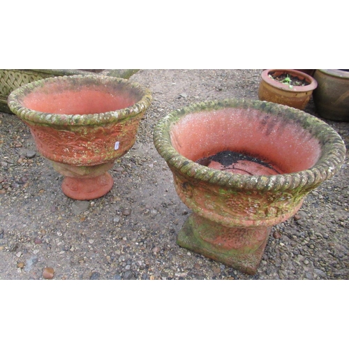 2309 - Reconstituted stone terracotta effect urns with fruit and floral design