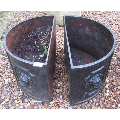 2289 - Pair of half moon cast iron planters with lion motif, 79cm x 26cm x 30cm