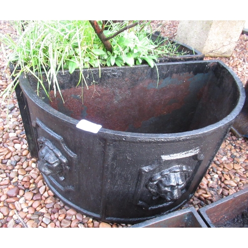 2290 - Pair of half moon cast iron planters with lion motif, 79cm x 26cm x 30cm