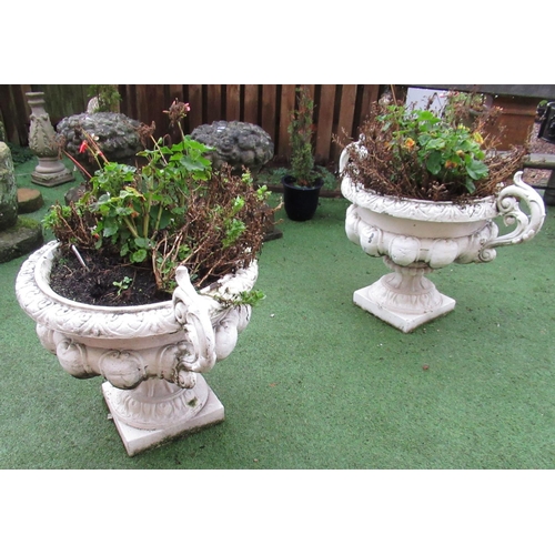 2302 - Large pair of cast iron urns, with ornate floral handles and scroll rims, on square bases, (2)