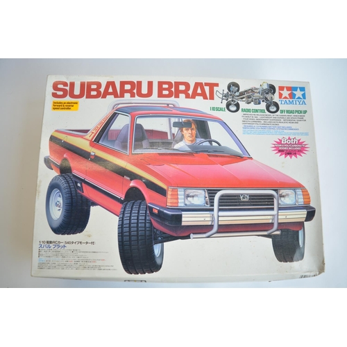 302 - Stock Tamiya Suburu Brat, 2WD 1/10th scale radio control car. Model has been started and chassis par... 