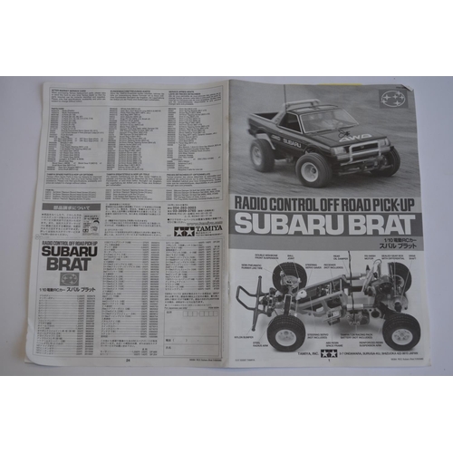 302 - Stock Tamiya Suburu Brat, 2WD 1/10th scale radio control car. Model has been started and chassis par... 