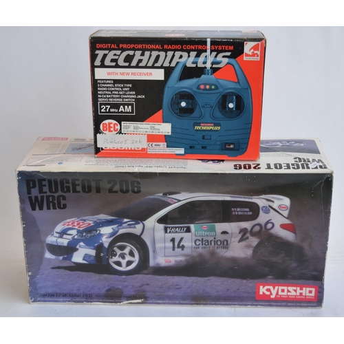 310 - Boxed Kyosho 1/10 Peugeot 206 WRC radio control 4WD rally car. Chassis built but not run, bodyshell ... 