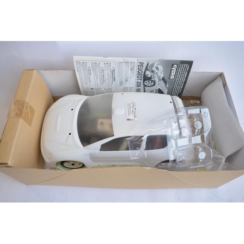 310 - Boxed Kyosho 1/10 Peugeot 206 WRC radio control 4WD rally car. Chassis built but not run, bodyshell ... 