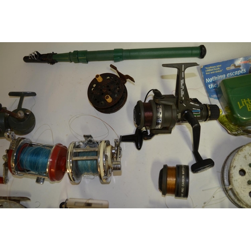 332 - A collection of fishing equpiment including side arm reels, multipliers, centrepin reels, fishing li... 