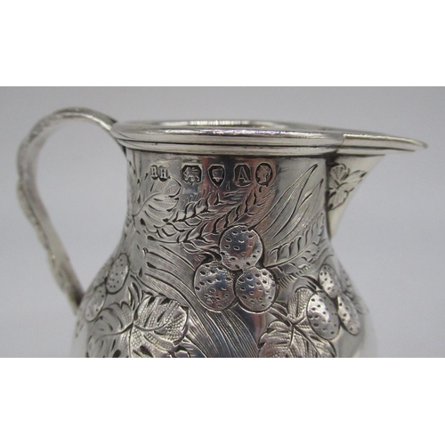 79 - Victorian hallmarked Sterling silver milk jug with repousse fruit detail, rope twist handle and lobe... 