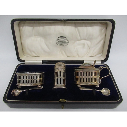 64 - Hallmarked Sterling silver cased three piece cruet set with blue glass liners on ball feet by Collin... 