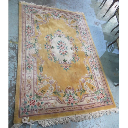 701 - A late c20th Chinese embossed wash woollen rug, old gold ground, central floral pattern medallion, w... 