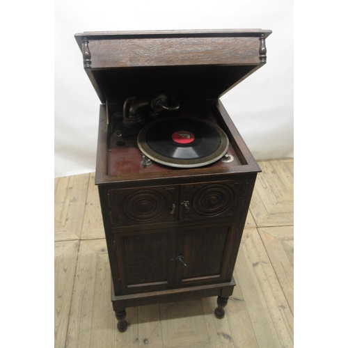 704 - c1920s HMV type oak cased free standing wind-up gramophone, with panelled doors, lower section being... 