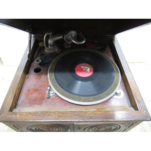 704 - c1920s HMV type oak cased free standing wind-up gramophone, with panelled doors, lower section being... 