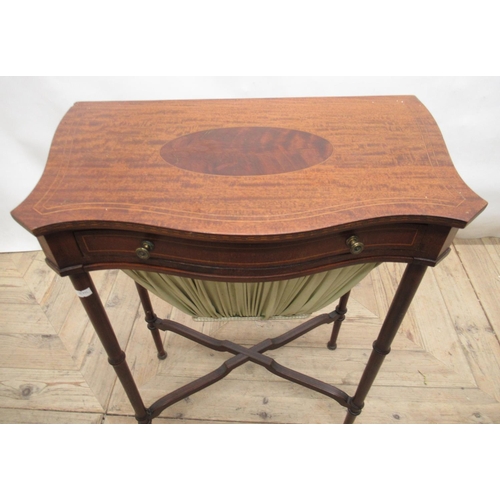 707 - c20th mahogany sewing table with inlaid serpentine top, single frieze drawer and pull-out bag, on tu... 