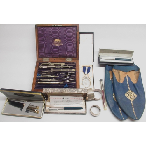 316 - Three hallmarked silver napkin rings, early 20th century W.H. Harling mathematical instrument set in... 