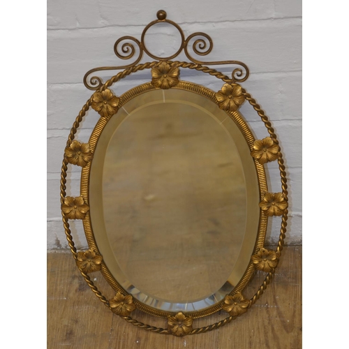 690 - Gilt framed oval mirror with bevelled edge and floral design, 47cm x 30cm