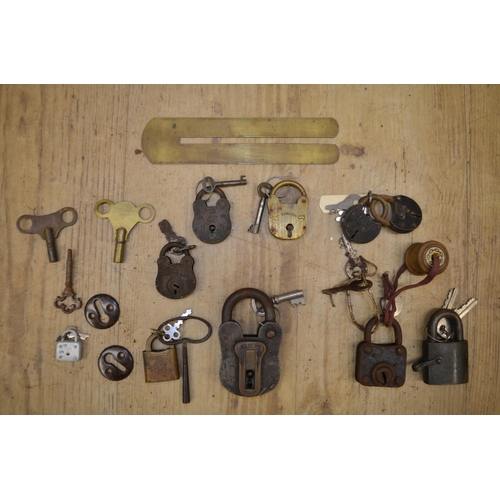 693 - Collection of vintage padlocks with keys, corkscrews, nutcrackers, bottle openers in metal carrying ... 