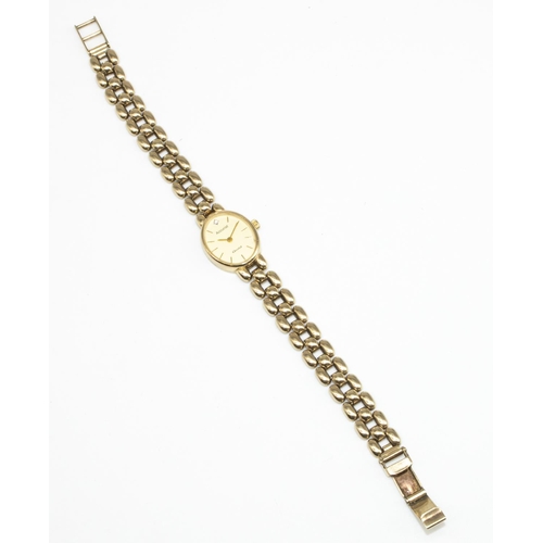 699 - Ladies Accurist 9ct gold cased quartz wristwatch with inset diamond, champagne coloured dial with ap... 