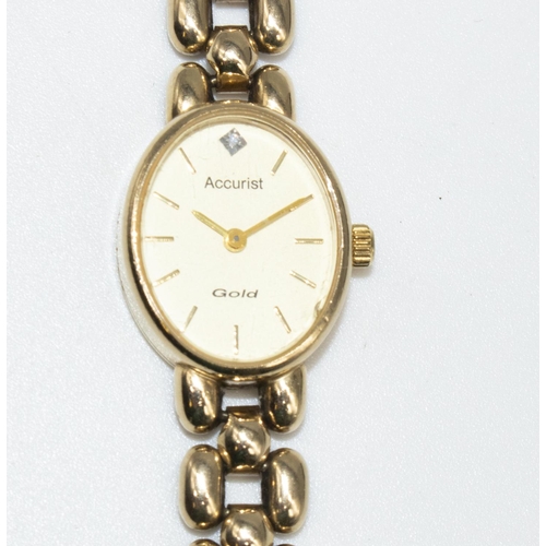 699 - Ladies Accurist 9ct gold cased quartz wristwatch with inset diamond, champagne coloured dial with ap... 