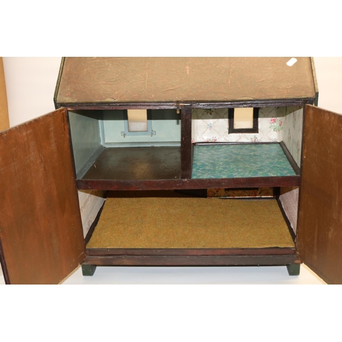 297 - 1920s double fronted dolls house with four glazed windows, the back opening to reveal three rooms, w... 