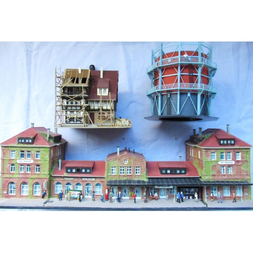 73 - Quality diorama railway stations with figures, shops etc. A scaffolding repair to a mock Tudor house... 